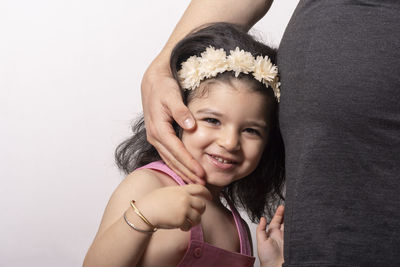 Portrait of smiling girl standing with mother