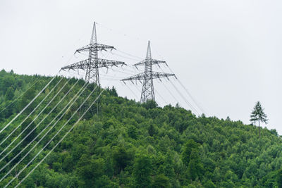 High voltage overhead power line, power pylon, steel lattice tower, mountains landscape austria.