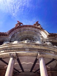 Low angle view of historical building against blue sky