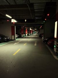 Road passing through illuminated city at night