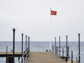 Deserted pontoon with red national flag of turkey. empty hotels, coronavirus covid19 quarantine. 