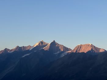 Scenic view of snowcapped mountains against clear sky