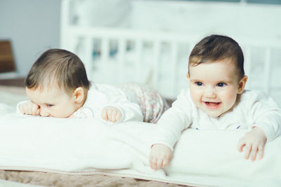 Portrait of cute baby lying on bed