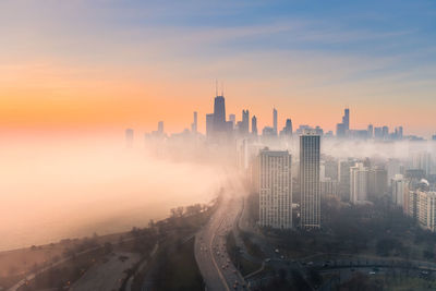 High angle view of buildings against sky during sunset