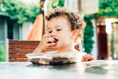 Portrait of boy looking away on table