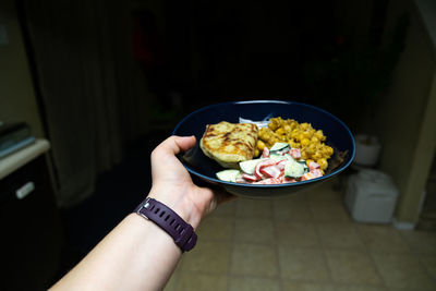 Midsection of person holding food in bowl