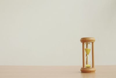 Close-up of illuminated lamp on table against white background