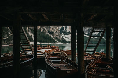 Boats moored on pier by sea