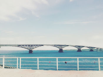 Arch bridge over sea against sky