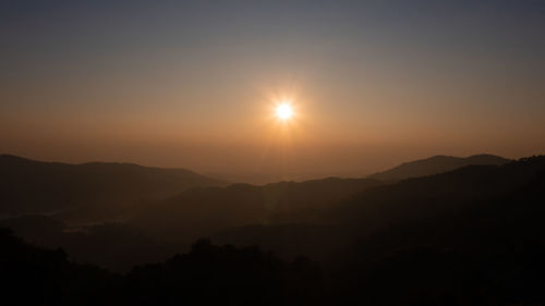 Scenic view of silhouette mountains against sky during sunset