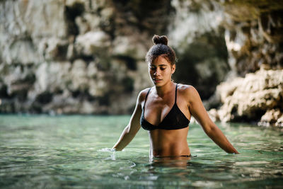 Portrait of young woman in water