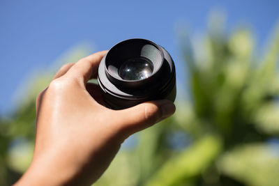 Close-up of hand holding lens