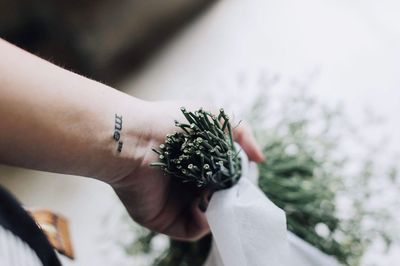 Close-up of hand holding flower bouquet