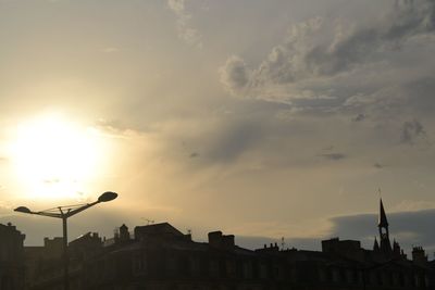 Low angle view of buildings against sky at sunset