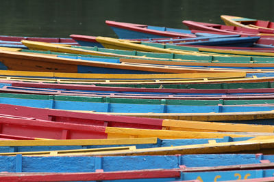 Multi colored rowboats moored in lake