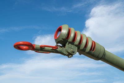 The barrel of an artillery piece against a blue sky background