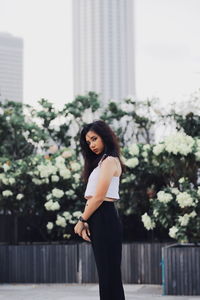 Portrait of woman standing against wall