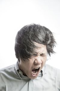 Woman screaming over white background