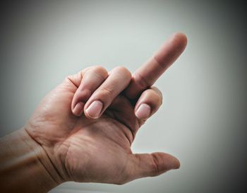 Close-up of human hand against white background