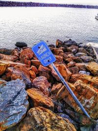 Close-up of pebbles on beach against sky