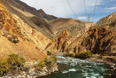 Mountain river and power lines. kokemeren river in naryn region of kyrgyzstan.