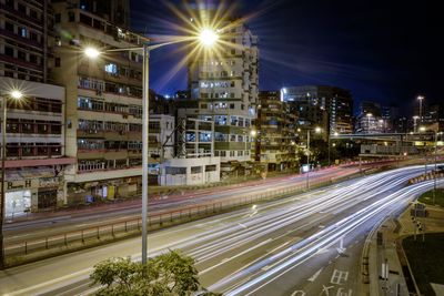 Light trails on road in city at night