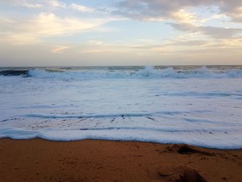 Scenic view of beach against sky during sunset