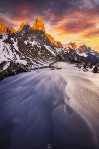 Scenic view of snowcapped mountains against sky during sunset