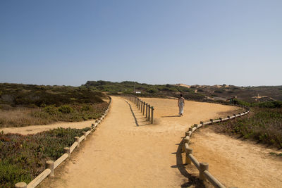 Footpath against clear sky