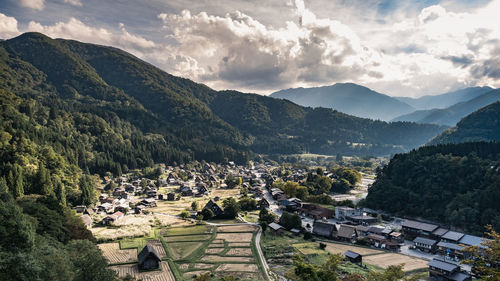 High angle view of buildings and mountains against sky