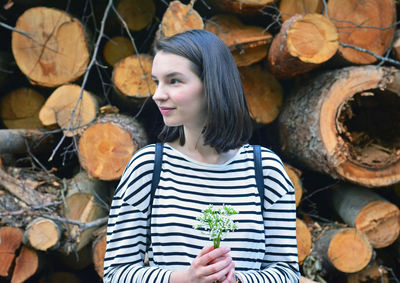 Young woman standing on log