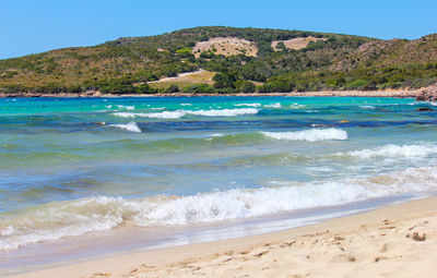 Scenic view of beach against blue sky