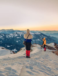 Rear view of people on mountain during winter