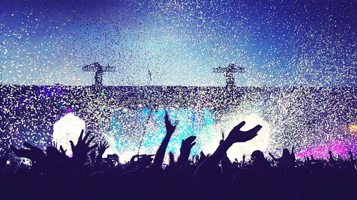 People enjoying concert at night