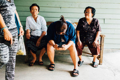 Group of people sitting on bench