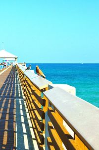 Scenic view of sea against clear blue sky