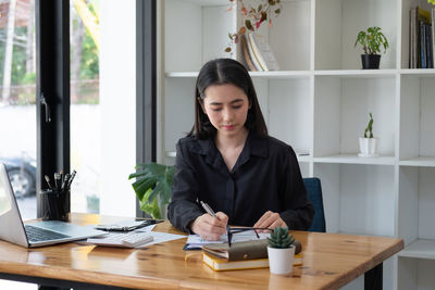 Portrait of young businesswoman working at office