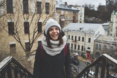 Portrait of woman standing in city