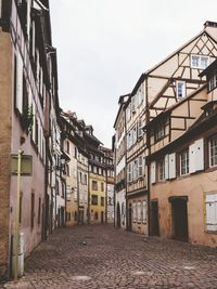 Street amidst buildings in town against sky