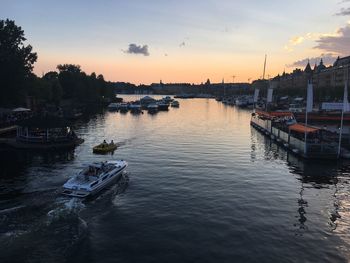 Boats in harbor at sunset