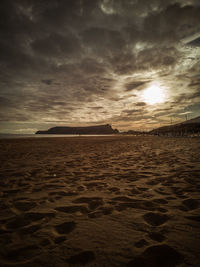 Scenic view of beach against sky during sunset