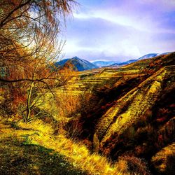 Scenic view of mountains against cloudy sky