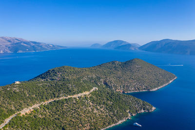 High angle view of sea against clear blue sky