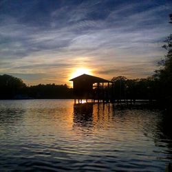 Scenic view of river against sky at dusk