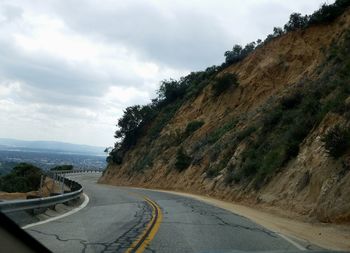 Road amidst mountains against sky