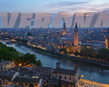 High angle view of illuminated buildings in city at dusk