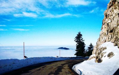 Scenic view of snowcapped mountains against blue sky