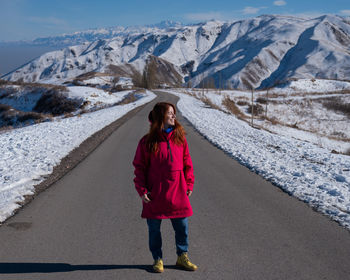 Rear view of woman walking on road