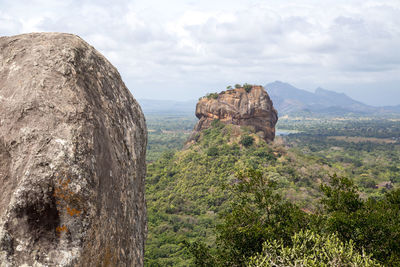 Rock formations on landscape against sky