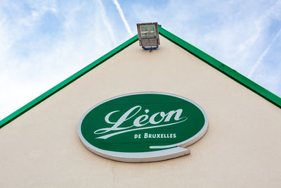 Low angle view of road sign against sky